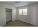 This bedroom features neutral carpet, a window with blinds, and a closet with sliding doors at 1349 Goldenglow Rd, Las Vegas, NV 89108