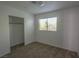 Comfortable bedroom features a closet, bright window, and neutral carpeting at 1349 Goldenglow Rd, Las Vegas, NV 89108