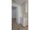 Hallway featuring carpet and cabinets and leading to a door at 1349 Goldenglow Rd, Las Vegas, NV 89108