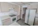 Bright kitchen features tile floors, wood cabinets, and white appliances at 1349 Goldenglow Rd, Las Vegas, NV 89108