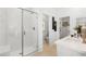 Bright bathroom featuring a glass-enclosed shower, walk-in closet, and white quartz countertops at 1485 Melodic Lark Ln, Las Vegas, NV 89138