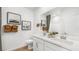 Bathroom featuring double sinks, white cabinets, quartz countertops, and decorative wall art at 1485 Melodic Lark Ln, Las Vegas, NV 89138
