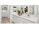 Elegant bathroom with double sinks, white cabinetry, quartz countertop, and walk-in closet at 1485 Melodic Lark Ln, Las Vegas, NV 89138
