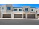 Modern townhome featuring a multi-car garage and a balcony on the second level at 1485 Melodic Lark Ln, Las Vegas, NV 89138