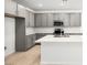 Modern kitchen with gray cabinets, stainless steel appliances, and a white countertop island at 1485 Melodic Lark Ln, Las Vegas, NV 89138