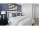Stylish bedroom featuring a navy accent wall, mirrored decor, and a plush bed at 1491 Melodic Lark Dr, Las Vegas, NV 89138