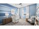 Bright bedroom with a blue accent wall, crib, and furnishings offering a calming space at 1491 Melodic Lark Dr, Las Vegas, NV 89138