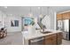 Bright kitchen featuring stainless steel appliances, a kitchen island and modern pendant lighting at 1491 Melodic Lark Dr, Las Vegas, NV 89138