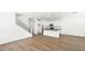 An open-concept home with wood-look tile floors adjoins the kitchen with white cabinets and a central island at 1491 Melodic Lark Dr, Las Vegas, NV 89138