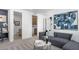 Comfortable living room with modern decor, leading to a bathroom and laundry area at 1491 Melodic Lark Dr, Las Vegas, NV 89138