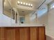 Well-lit bathroom with a large mirror, vanity with wood cabinets, and shower-tub combo at 2132 Tierra Del Verde St, Las Vegas, NV 89156