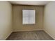 Neutral bedroom featuring carpet floors, a window with blinds, and light-colored walls at 2132 Tierra Del Verde St, Las Vegas, NV 89156