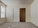 Neutral bedroom featuring carpet floors, a window with blinds, and closet with sliding doors at 2132 Tierra Del Verde St, Las Vegas, NV 89156