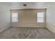 Spacious carpeted bedroom with plenty of natural light from two windows, and neutral walls at 2132 Tierra Del Verde St, Las Vegas, NV 89156