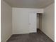 Cozy bedroom with neutral walls, carpet flooring, and closet with sliding doors at 2132 Tierra Del Verde St, Las Vegas, NV 89156