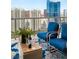 City view balcony featuring blue chairs, wine glasses, and an area rug at 222 Karen Ave # 3305, Las Vegas, NV 89109