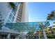 Exterior view of a high-rise building with a glass covered entryway and palm trees at 222 Karen Ave # 3305, Las Vegas, NV 89109