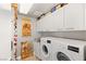 Well-equipped laundry room with modern washer and dryer and storage cabinets at 222 Karen Ave # 3305, Las Vegas, NV 89109