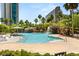 Resort-style pool with waterfalls, palm trees, lounge chairs, and lush landscaping for ultimate relaxation at 222 Karen Ave # 3305, Las Vegas, NV 89109