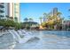 Resort-style pool with waterfalls, palm trees, lounge chairs inside of the pool, and lush landscaping at 222 Karen Ave # 3305, Las Vegas, NV 89109