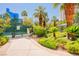 Tennis court surrounded by lush landscaping with mature palm trees in a serene environment at 222 Karen Ave # 3305, Las Vegas, NV 89109