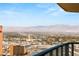 Expansive city and mountain view from a high-rise balcony featuring a glass railing and clear blue sky at 222 Karen Ave # 3305, Las Vegas, NV 89109