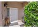 Front entryway featuring a secure door, modern lighting, and lush greenery, creating a warm and inviting welcome at 2305 W Horizon Ridge Pkwy # 611, Henderson, NV 89052