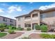 Charming exterior with neutral stucco, private balconies, covered entry, and manicured landscaping, creating a welcoming atmosphere at 2305 W Horizon Ridge Pkwy # 611, Henderson, NV 89052