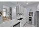 Modern kitchen with white countertops and cabinets, stainless steel fridge, and open view to the living area at 2305 W Horizon Ridge Pkwy # 611, Henderson, NV 89052