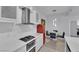Well-lit kitchen featuring a retro refrigerator, stainless steel hood, and white cabinetry at 2305 W Horizon Ridge Pkwy # 611, Henderson, NV 89052