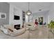 Modern open concept living room featuring stylish furnishings, a cozy fireplace, and seamless flow to the dining area at 2305 W Horizon Ridge Pkwy # 611, Henderson, NV 89052