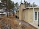 Single story home with gravel yard, mature trees, a chimney, and a set of French doors at 2451 E Falcon St, Pahrump, NV 89048