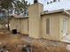 Single story home with gravel yard, mature trees, a chimney, and a set of French doors at 2451 E Falcon St, Pahrump, NV 89048