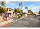 View of the community entrance with a gate, palm trees, and well-maintained landscaping at 2606 S Durango Dr # 276, Las Vegas, NV 89117