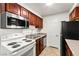 Updated kitchen with white appliances, microwave and wood cabinets at 2606 S Durango Dr # 276, Las Vegas, NV 89117