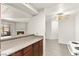 Open kitchen design with wood cabinets and new gray wood-look floors at 2606 S Durango Dr # 276, Las Vegas, NV 89117