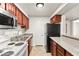Functional kitchen featuring granite countertops, wood cabinets, and stainless-steel appliances at 2606 S Durango Dr # 276, Las Vegas, NV 89117