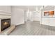 Bright living room features a cozy fireplace and modern gray wood-look flooring at 2606 S Durango Dr # 276, Las Vegas, NV 89117