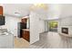 Living room with balcony access and fireplace open to the kitchen with bar seating at 2606 S Durango Dr # 276, Las Vegas, NV 89117
