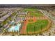 Aerial showcasing the community's baseball fields, tennis courts, pool and surrounding homes at 2787 Donatello Manor Pl, Henderson, NV 89044