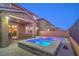 Backyard showcasing a colorful in-ground tub surrounded by a patio and block wall at 2787 Donatello Manor Pl, Henderson, NV 89044
