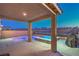 Backyard patio featuring an in-ground tub with mountain views at 2787 Donatello Manor Pl, Henderson, NV 89044