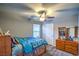 Cozy bedroom featuring carpet, a ceiling fan, and natural light streaming in through the window at 2787 Donatello Manor Pl, Henderson, NV 89044