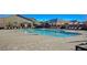 Inviting community pool surrounded by loungers and umbrellas, perfect for relaxation and leisure at 2787 Donatello Manor Pl, Henderson, NV 89044