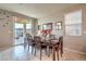 Cozy dining room with a wooden table, six chairs, and a view of the outdoor patio at 2787 Donatello Manor Pl, Henderson, NV 89044
