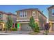 Two story home with desert landscaping and a two car garage on a brick driveway at 2787 Donatello Manor Pl, Henderson, NV 89044