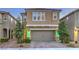 Charming two-story home featuring a neutral stucco facade, manicured landscaping, and a two-car garage at 2787 Donatello Manor Pl, Henderson, NV 89044