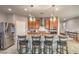 Kitchen island with granite countertops and pendant lighting, complete with stainless steel appliances at 2787 Donatello Manor Pl, Henderson, NV 89044