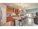 Kitchen island features granite countertops, stainless steel appliances, and wooden cabinets at 2787 Donatello Manor Pl, Henderson, NV 89044