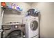 Functional laundry area features modern LG washer and dryer with storage shelf above at 2787 Donatello Manor Pl, Henderson, NV 89044